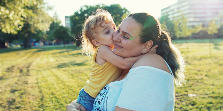 Modern real parents with body positive attitude, tattoos, piercings and positive lifestyle, spending afternoon with their kids in the park.