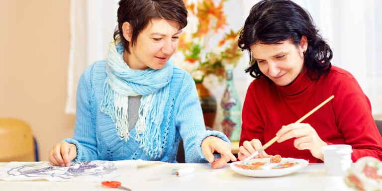 adult woman with special needs are engaged in handcraft in rehabilitation center