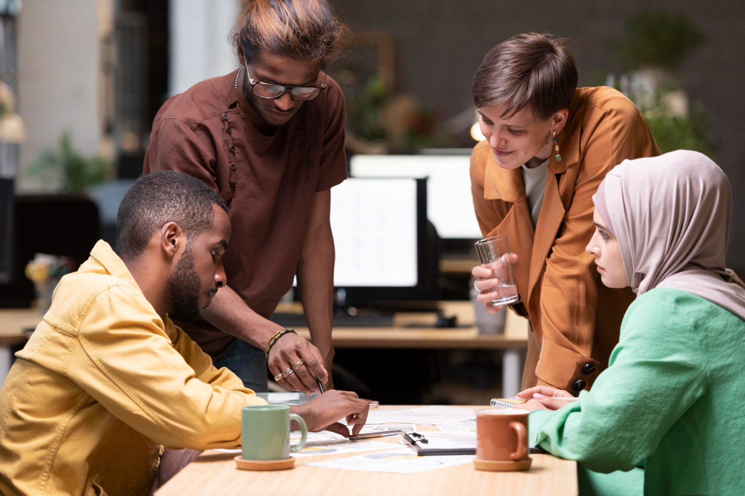 Diverse colleagues discussing project strategy during a collaborative group meeting.